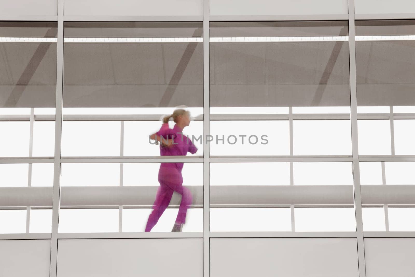 Female doctor running in a hospital corridor