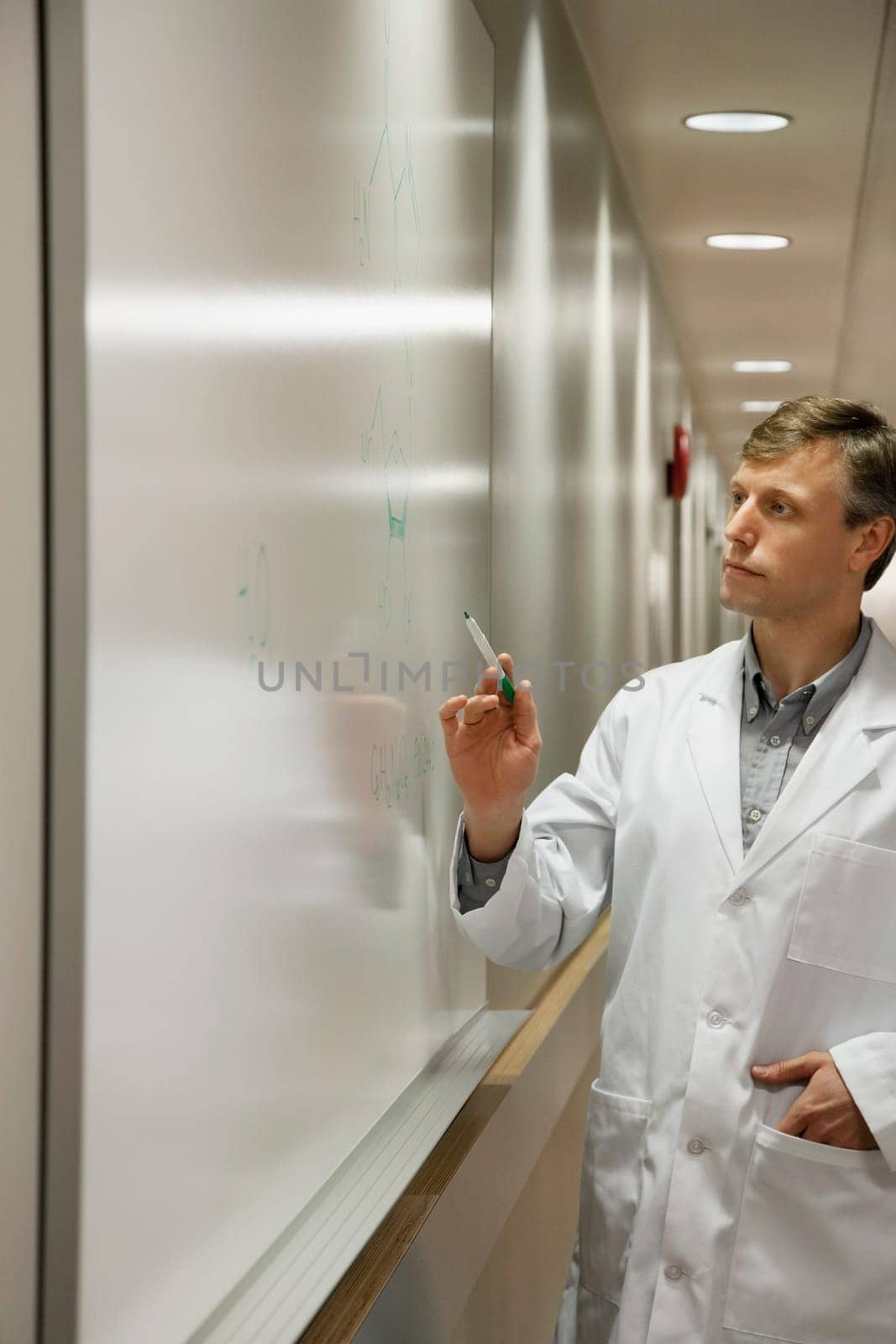 Doctor writing on a whiteboard in a hospital