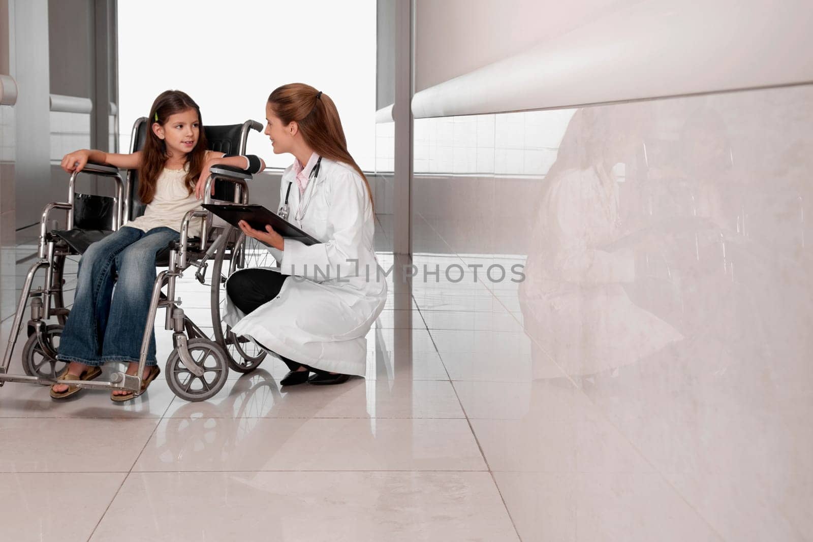 Female doctor with a patient in a wheelchair