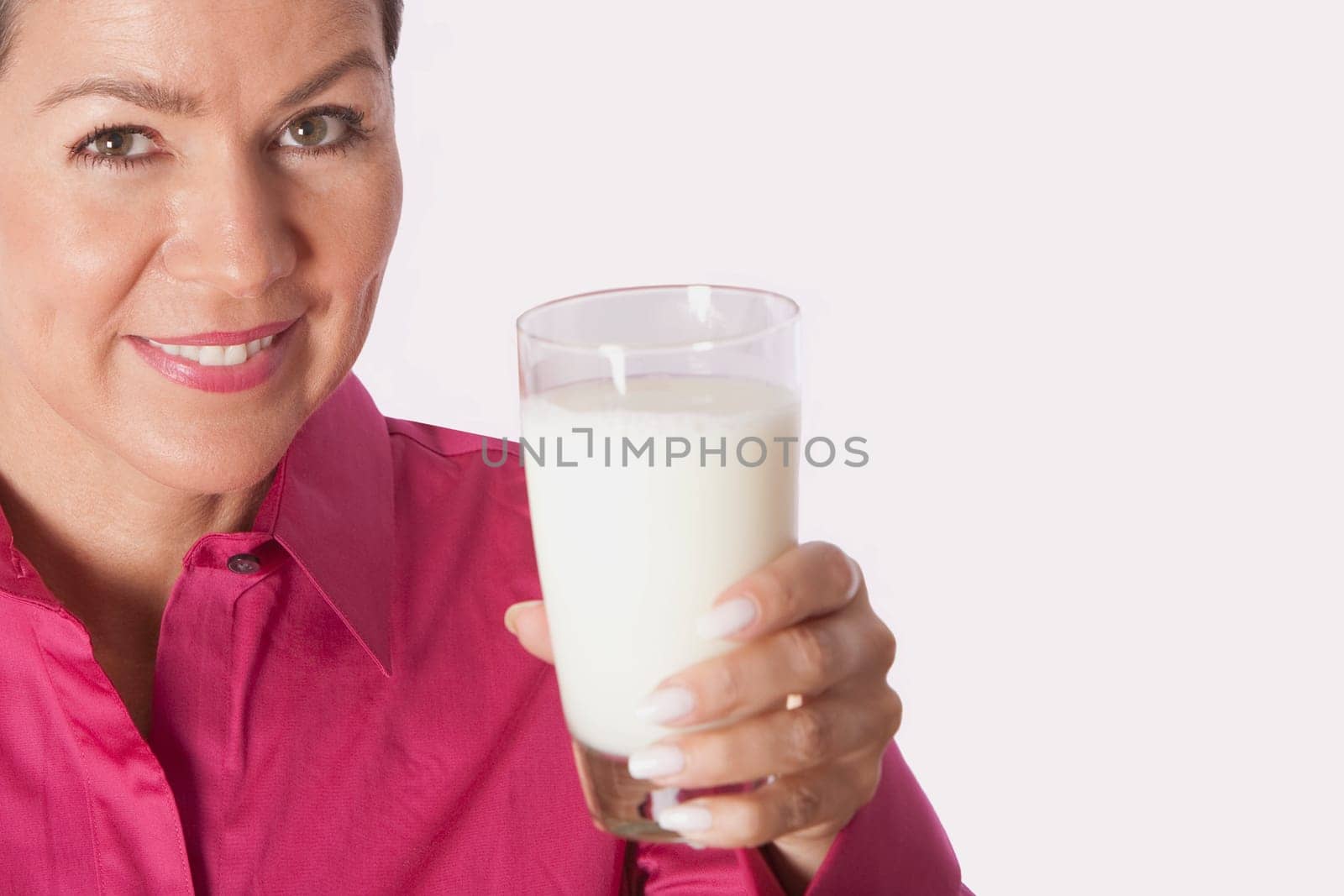Close_up of a woman holding a glass of milk