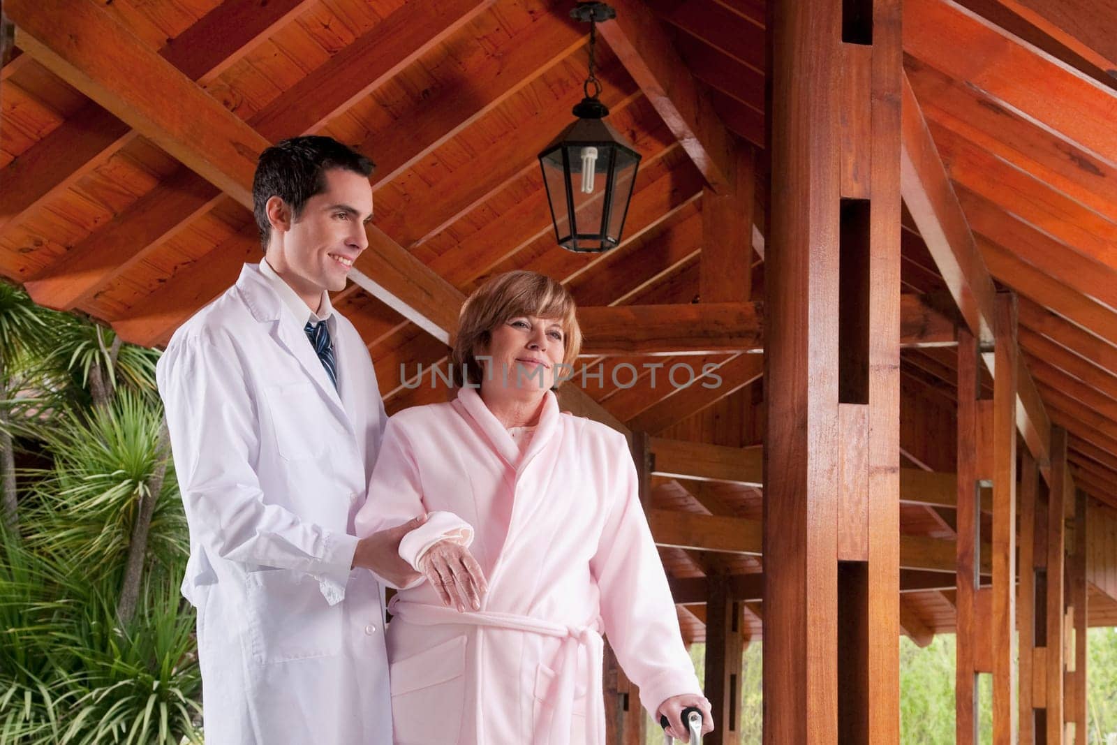 Doctor assisting a patient in walking in a rehabilitation centre