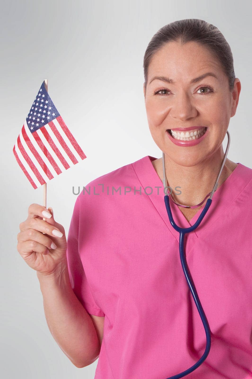Female doctor holding an American flag