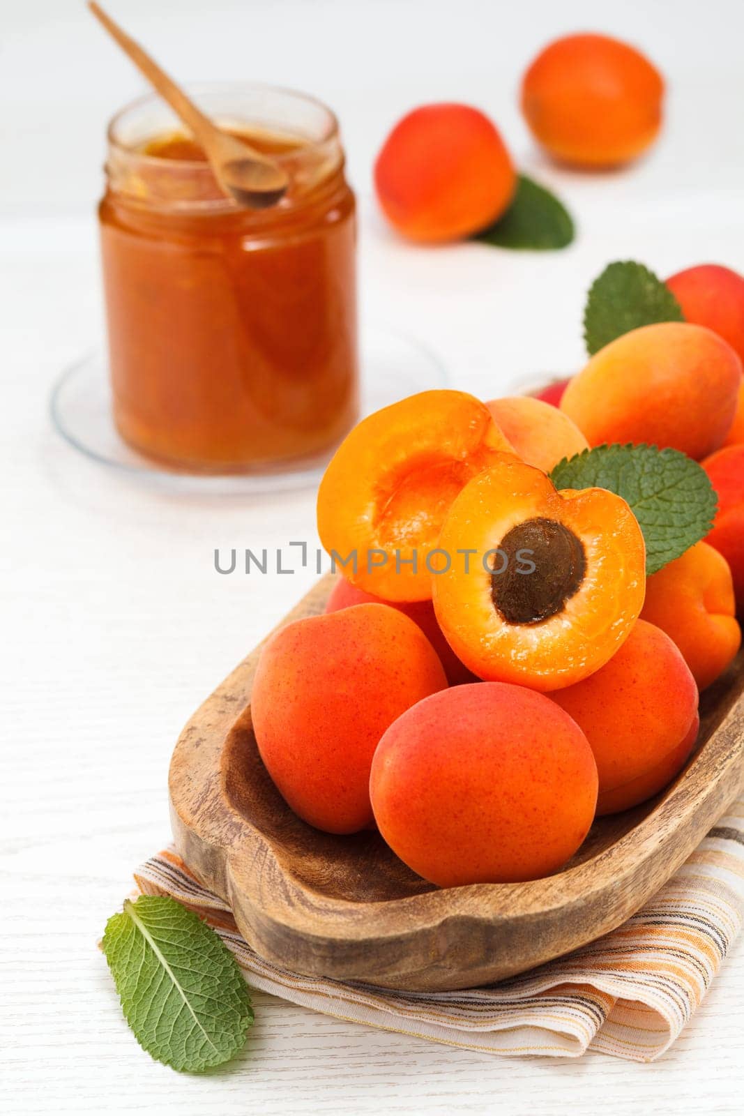 Apricots. Ripe fresh apricots on a wooden white background..