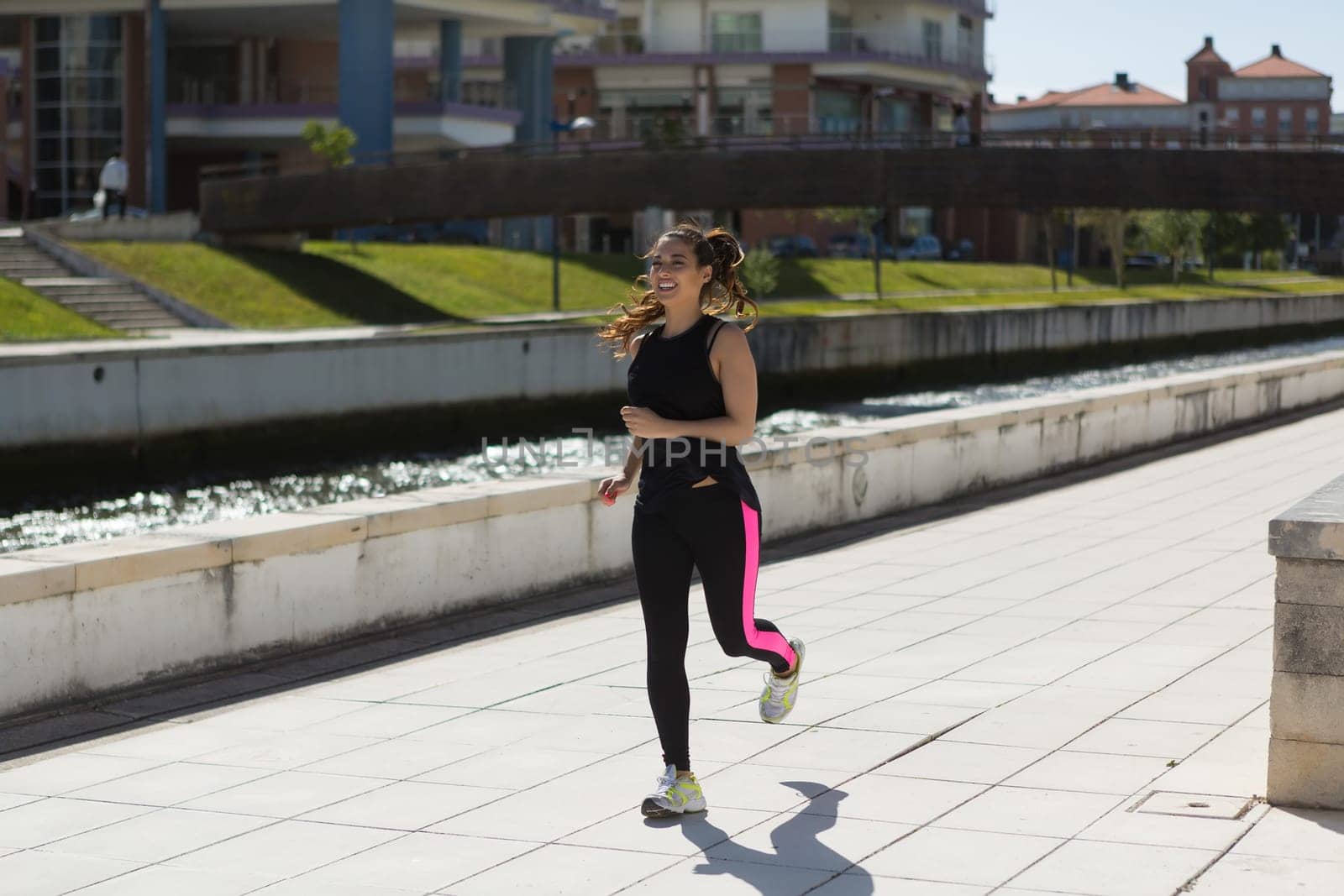 A beautiful young woman making some exercise at the park - fitness concept