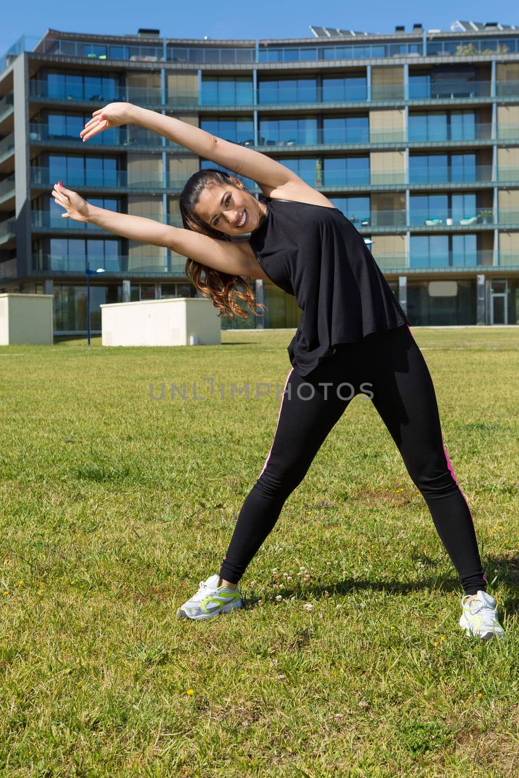A beautiful young woman making some exercise at the park - fitness concept