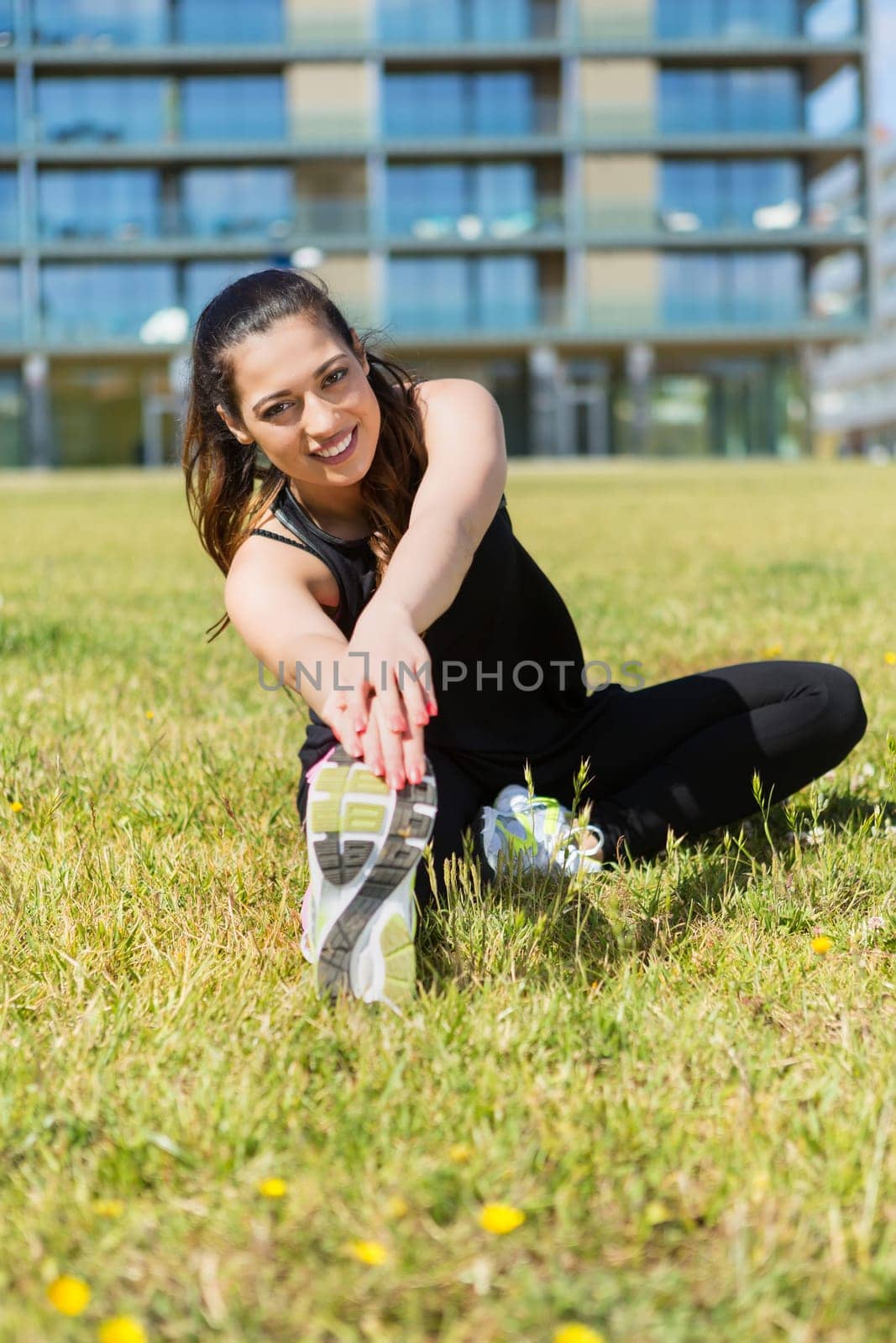 A beautiful young woman making some exercise at the park - fitness concept