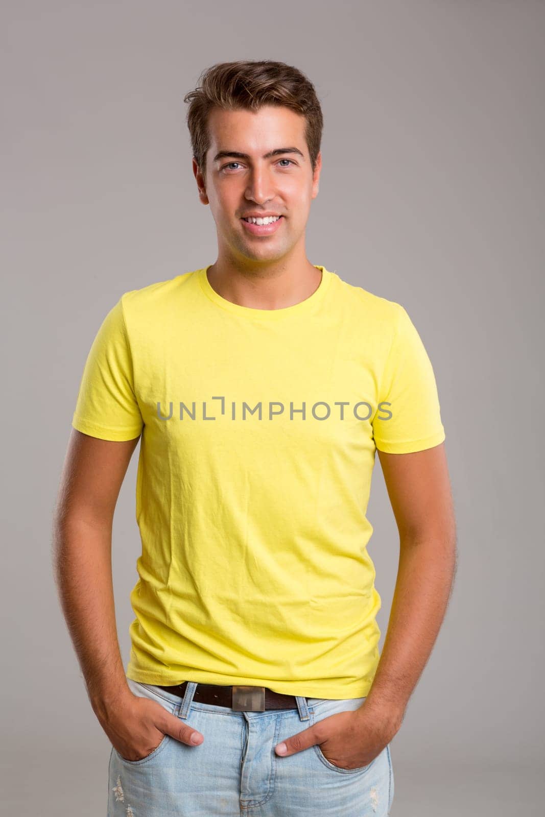 Studio picture of a young and handsome man posing isolated