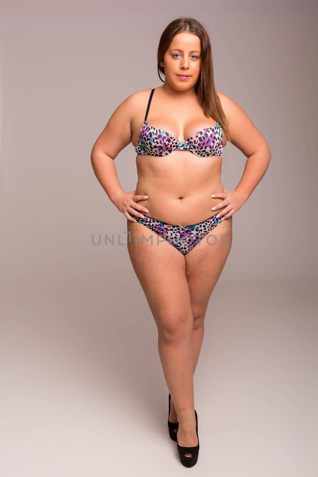 Beautiful large woman posing in lingerie - studio shot