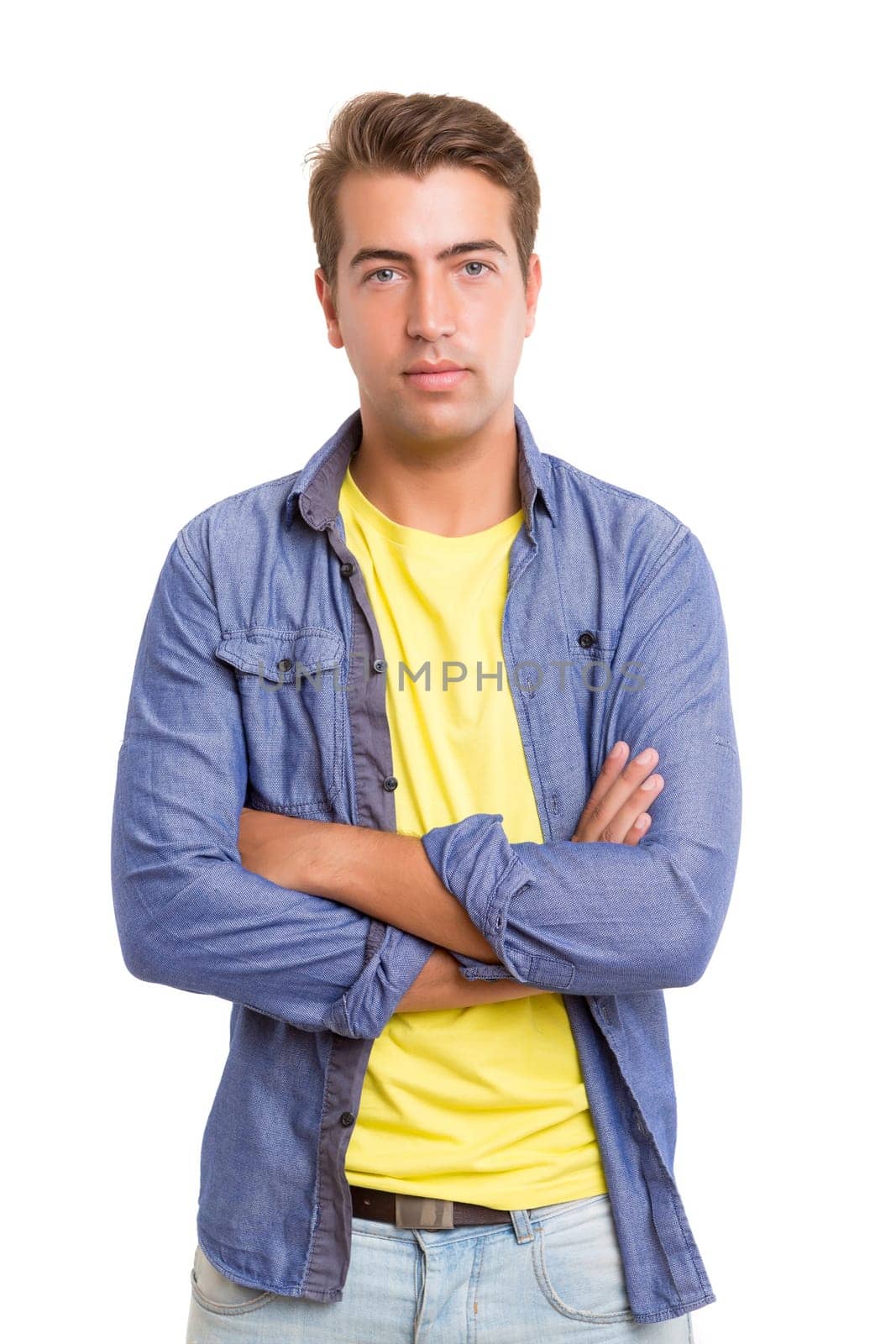 Studio picture of a young and handsome man posing isolated
