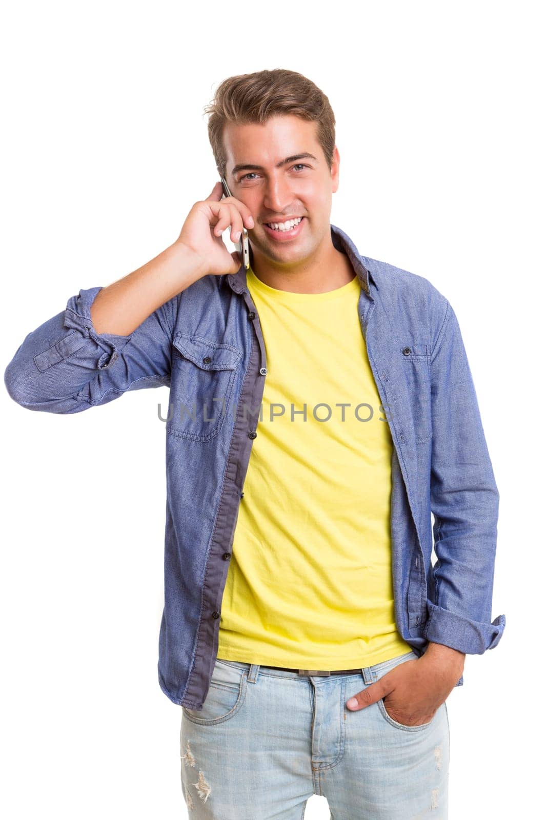 Young man at the phone, isolated over white