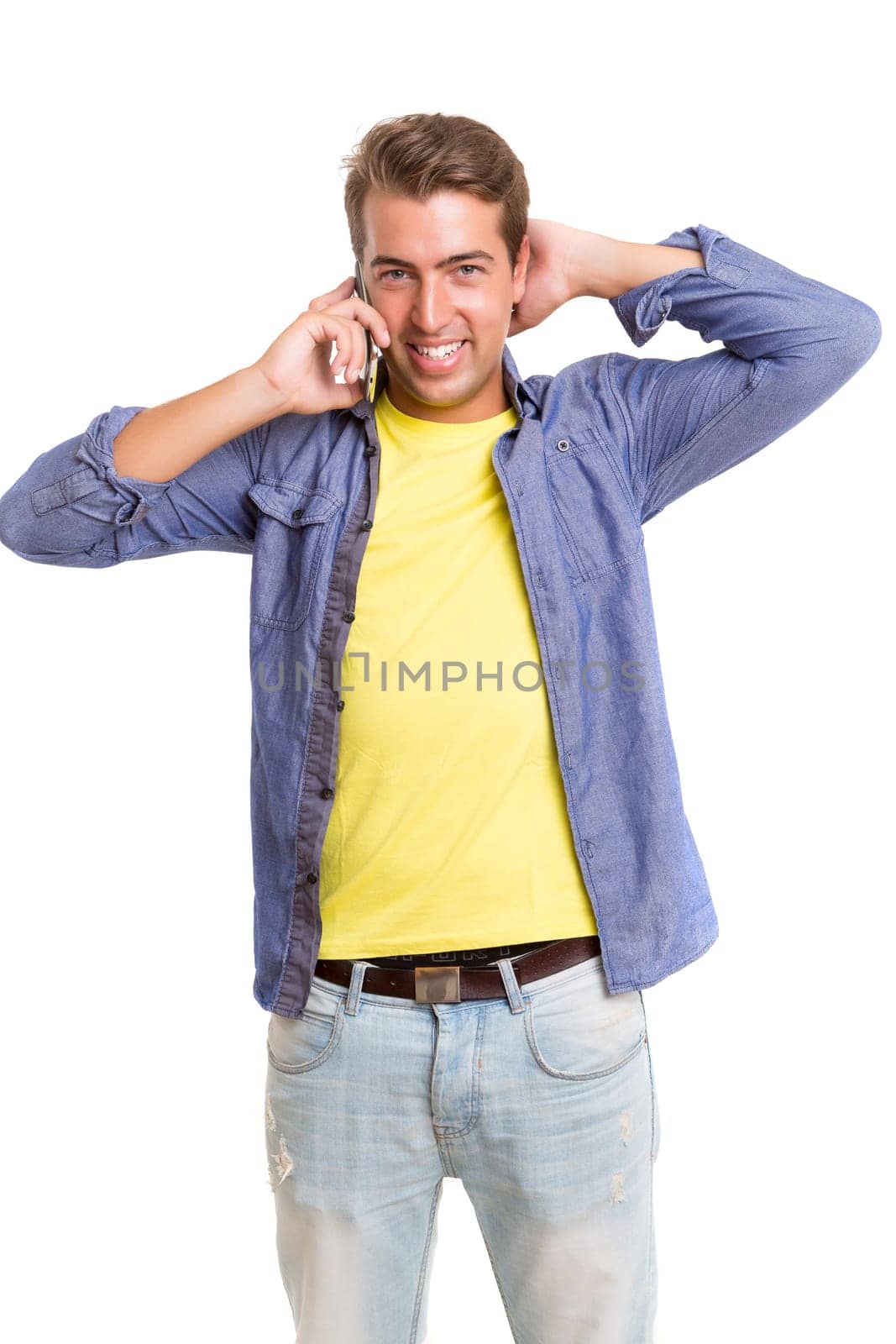 Young man at the phone, isolated over white