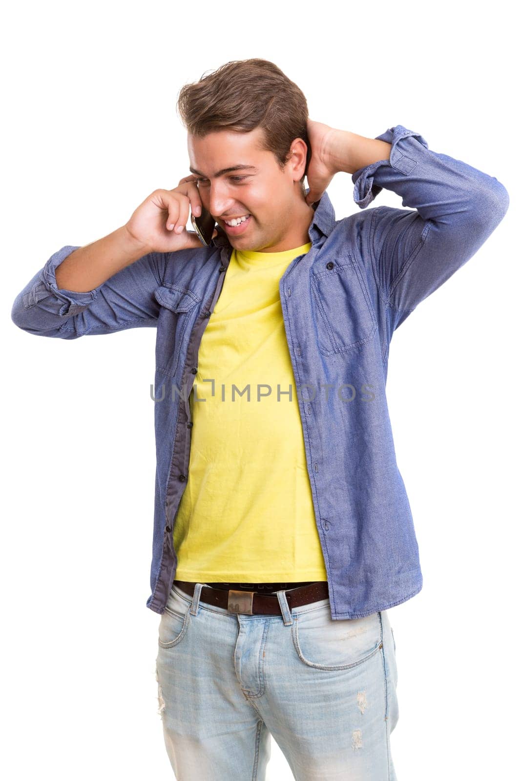 Young man at the phone, isolated over white