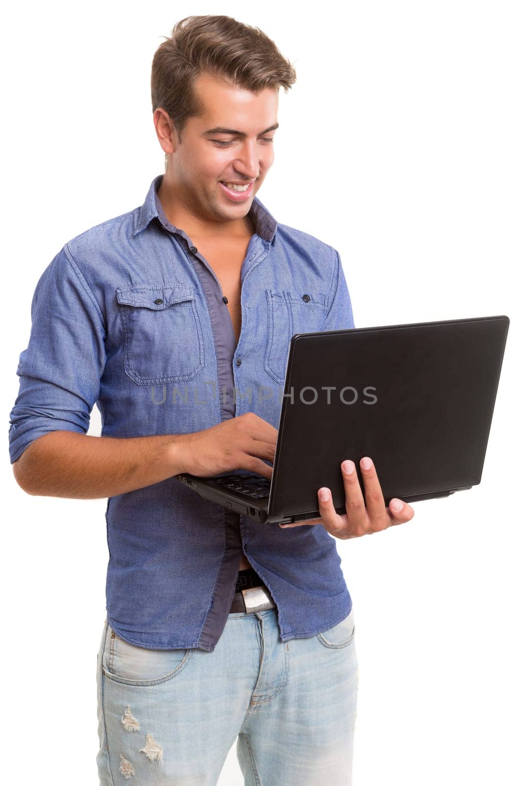 Young handsome man working with laptop computer