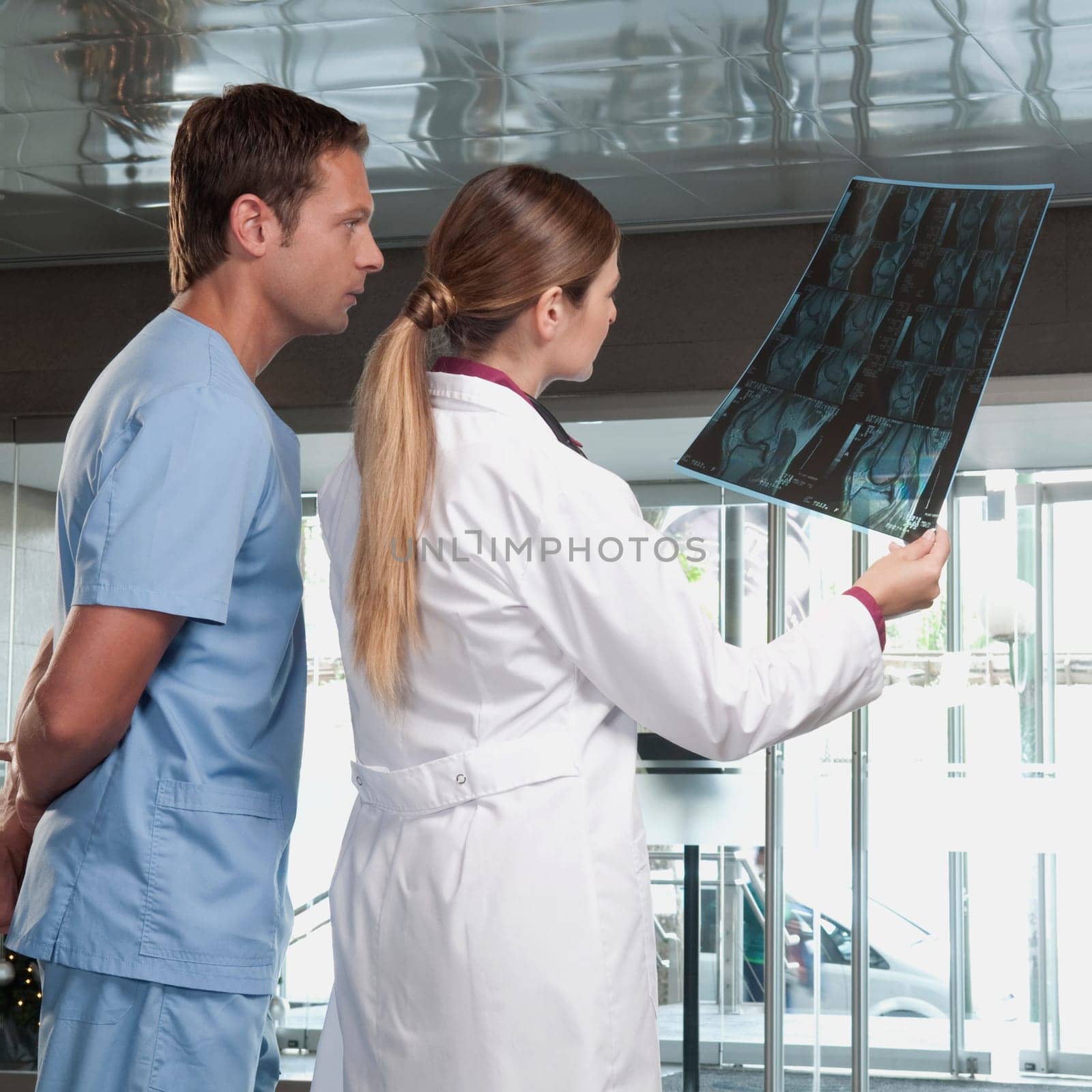 Doctor showing MRI scan to a male nurse