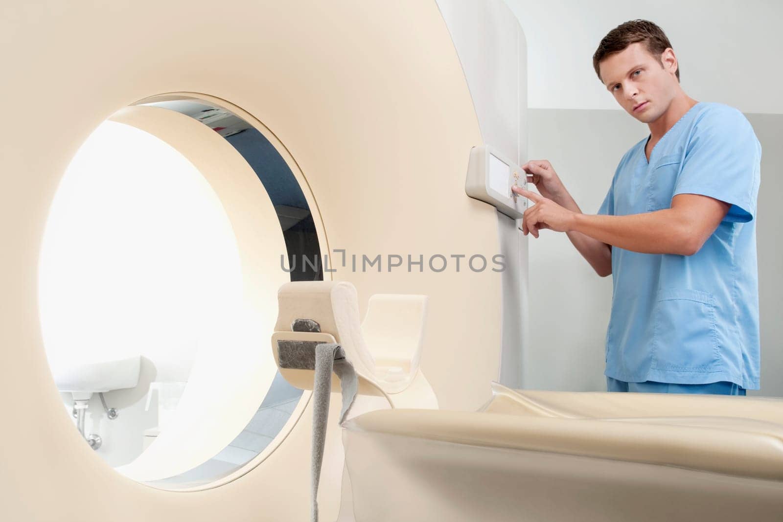 Technician operating an MRI scanner