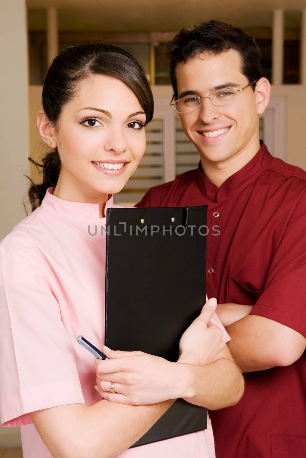 Portrait of a female doctor smiling with a male doctor