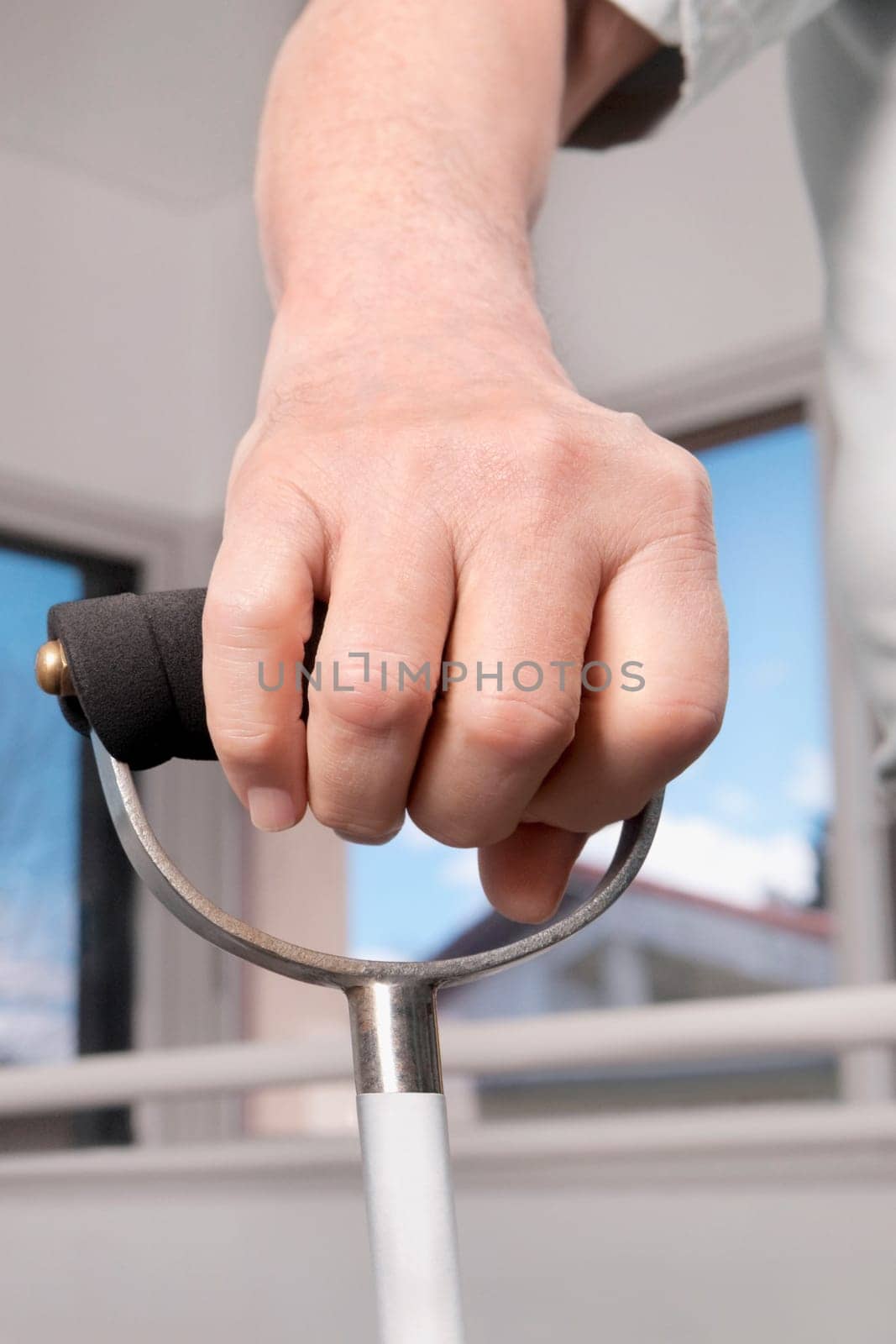 Human hand holding a crutch
