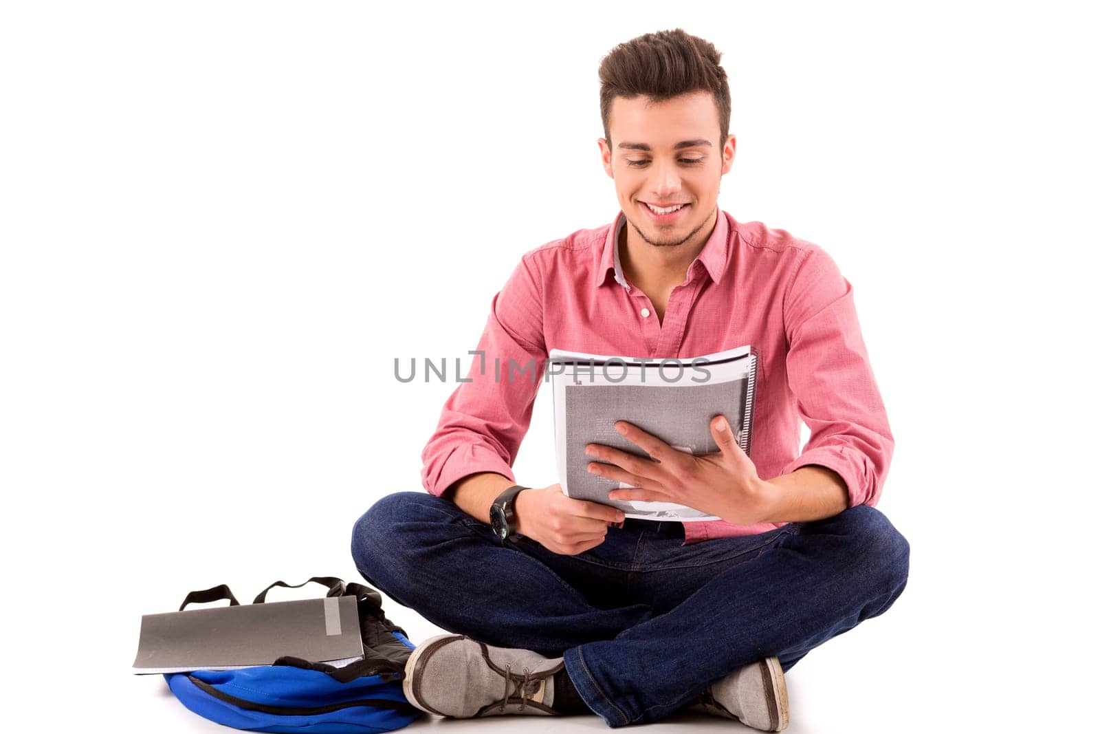 Young happy student posing isolated over white background