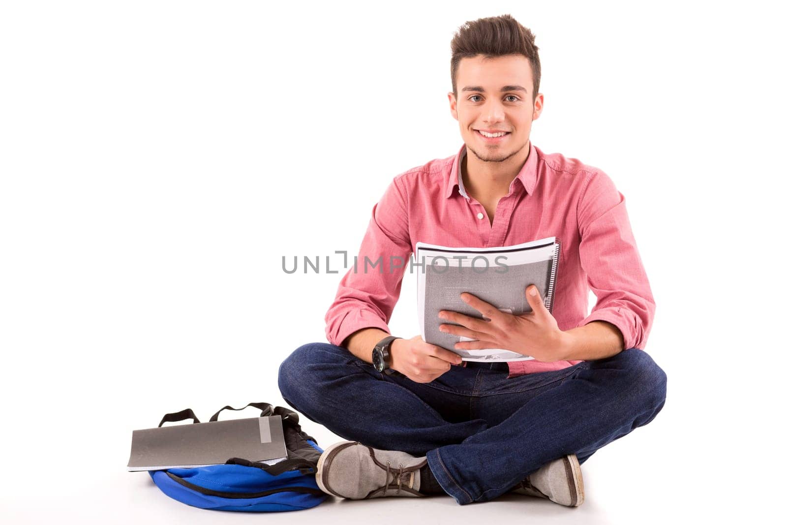 Young happy student posing isolated over white background