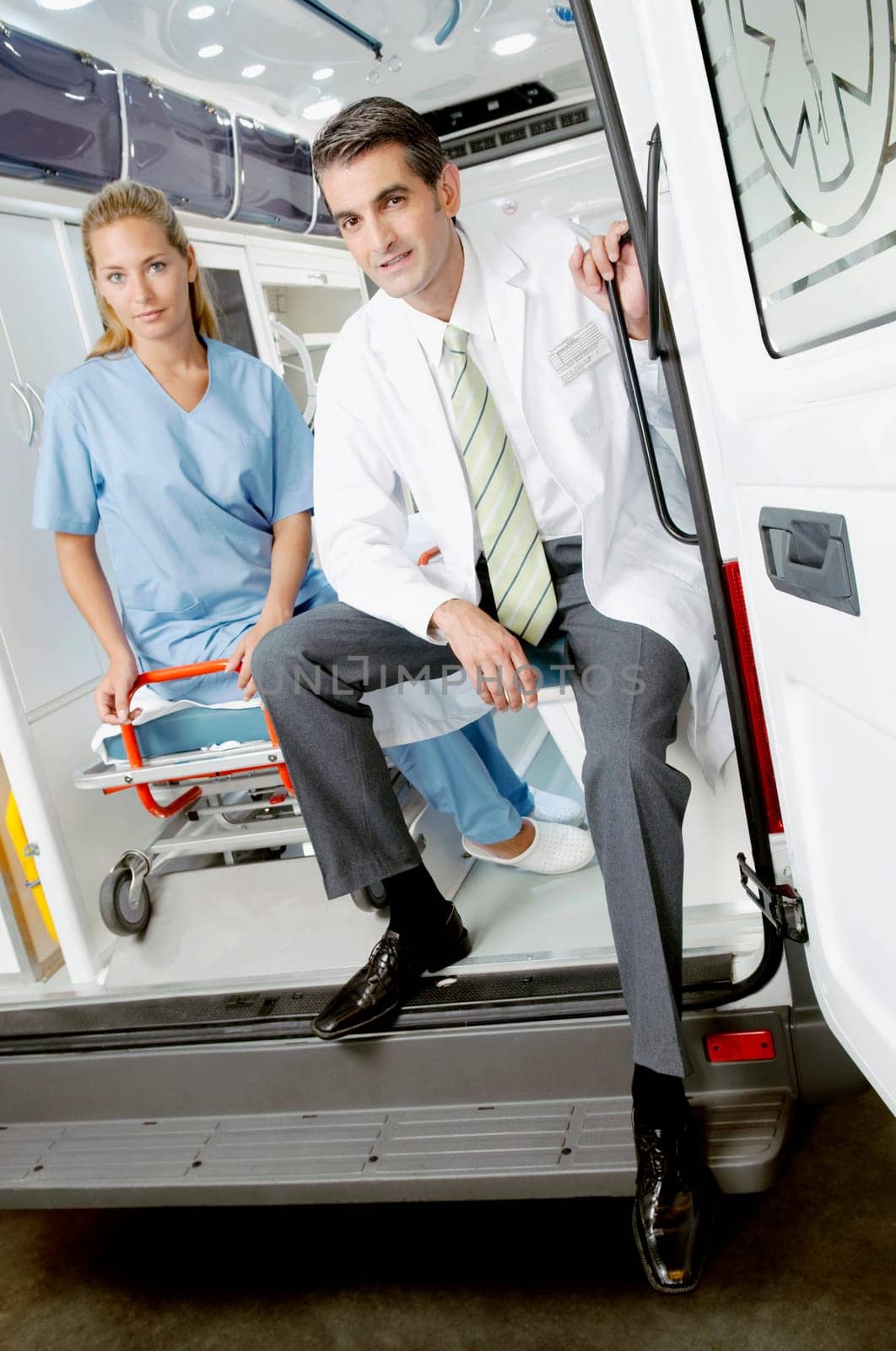 Doctor sitting with a female nurse in an ambulance