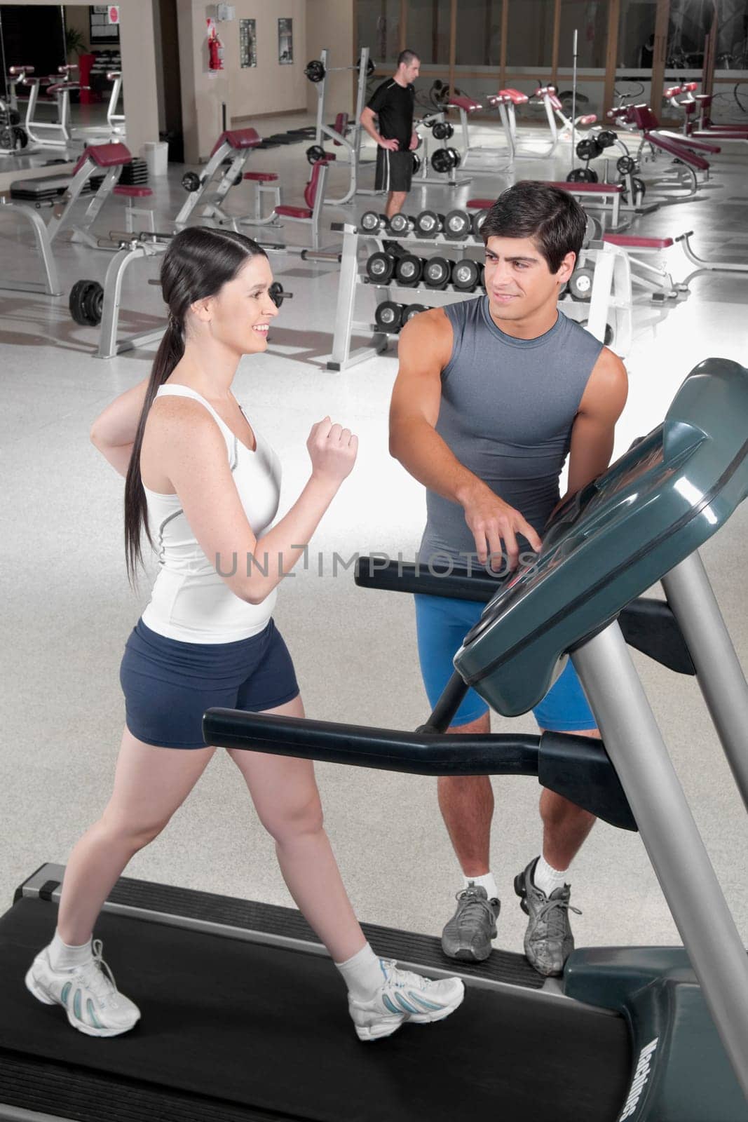 Man assisting a woman on a treadmill