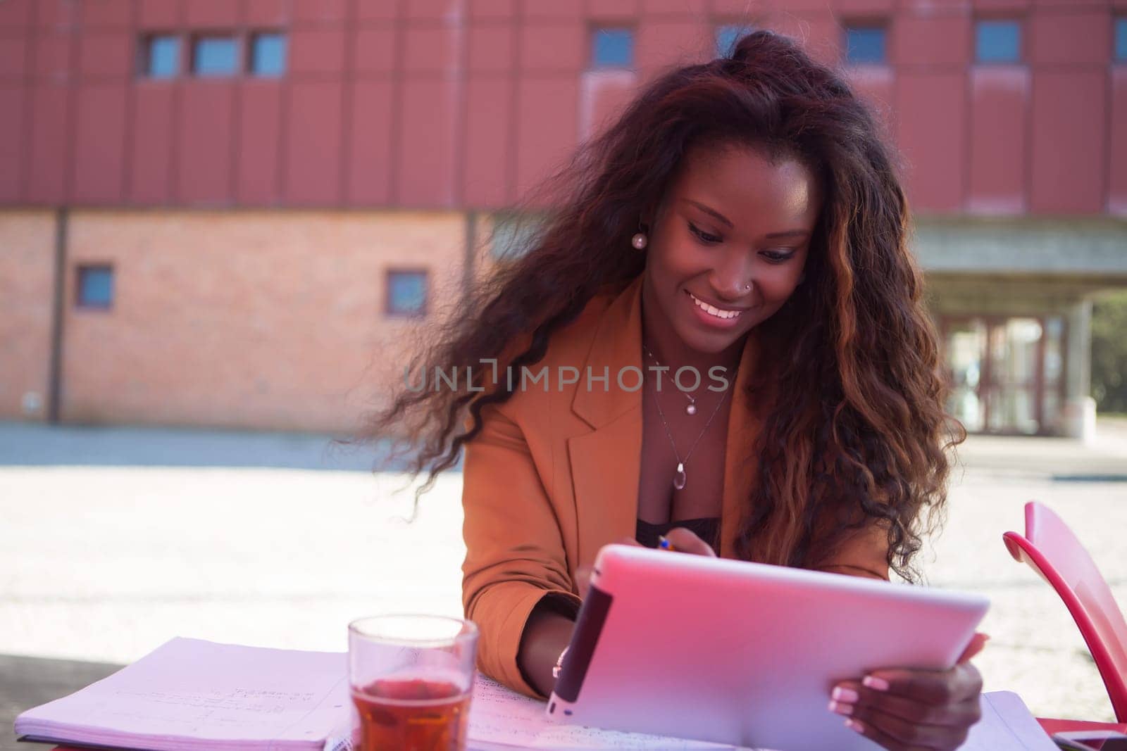 Young african student preparing her exams at a local cafeteria