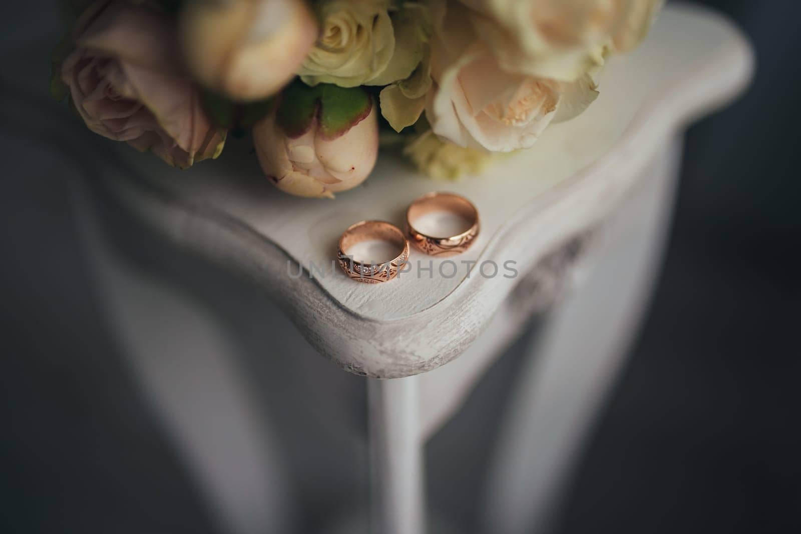 Wedding rings with flowers on the table. High quality photo