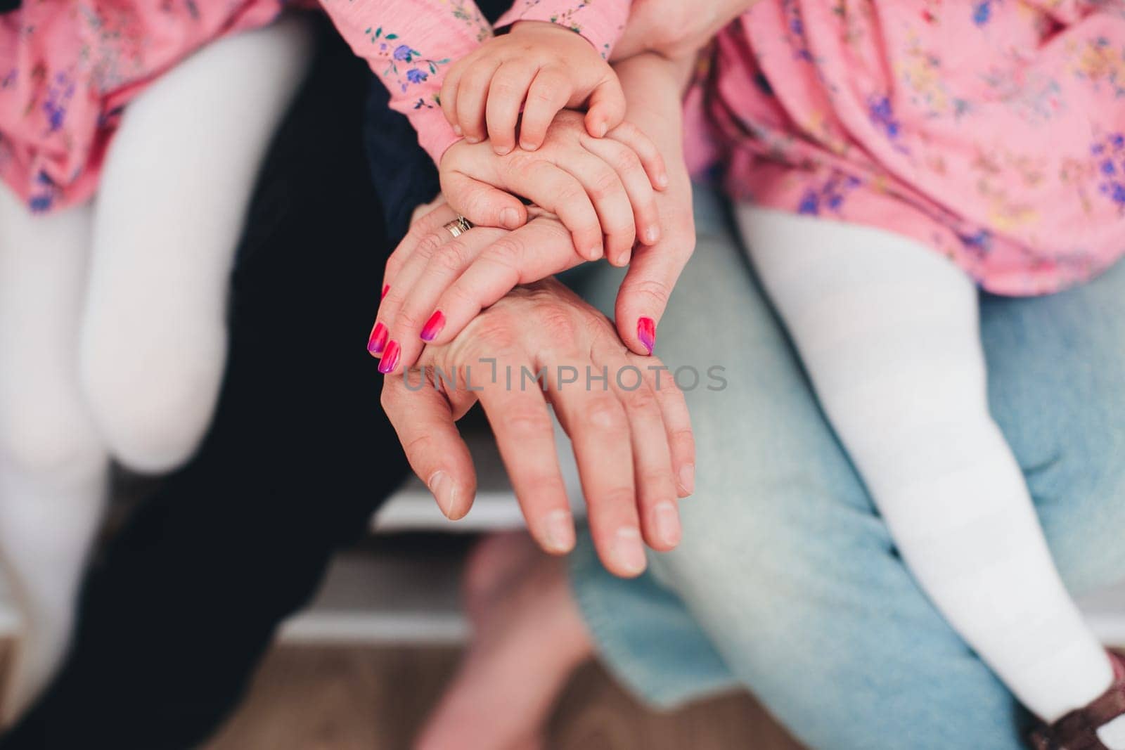 Family hands of four, mother, father and 2 kids. High quality photo