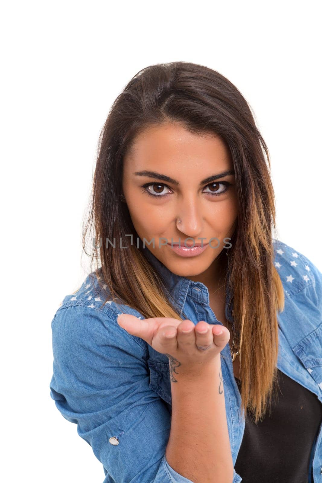 Beautiful young woman blowing you a kiss, isolated over white