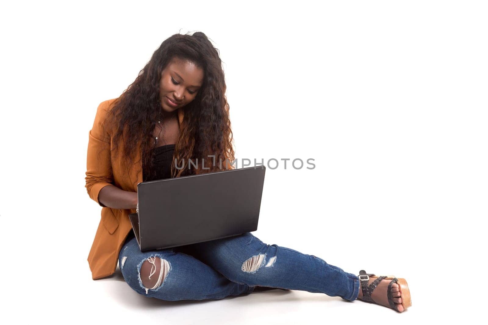 Young african student working with her laptop, isolated over a white background