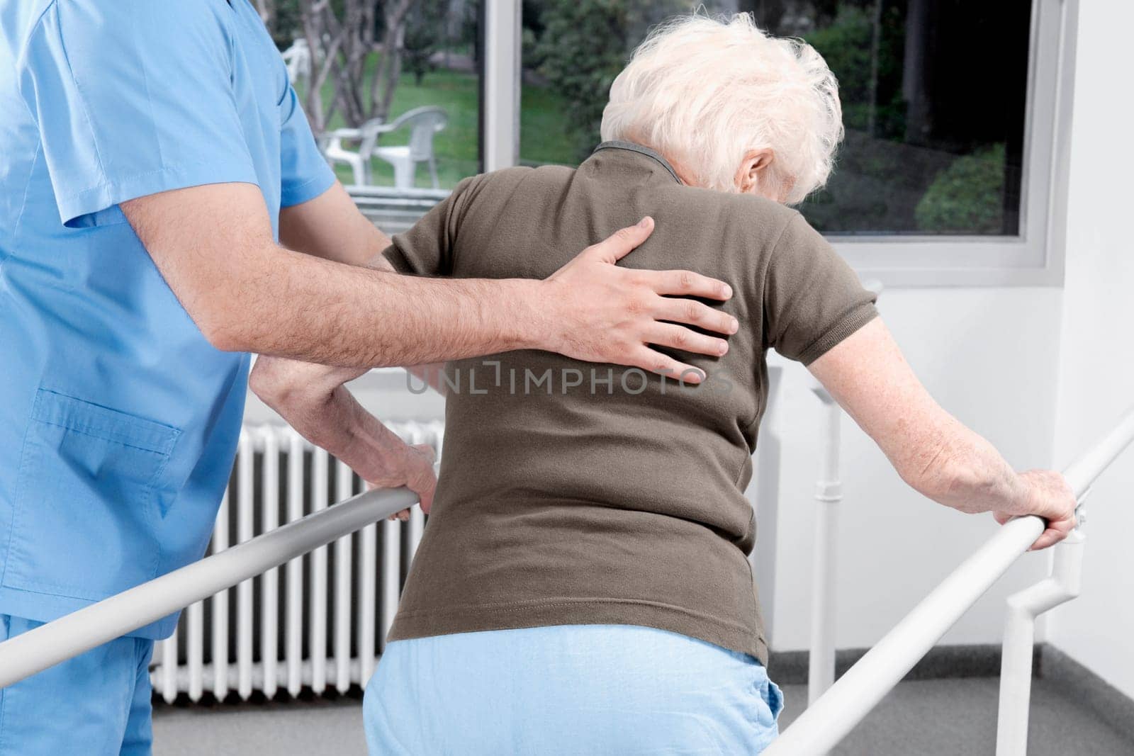 Health worker assisting a disabled woman in walking