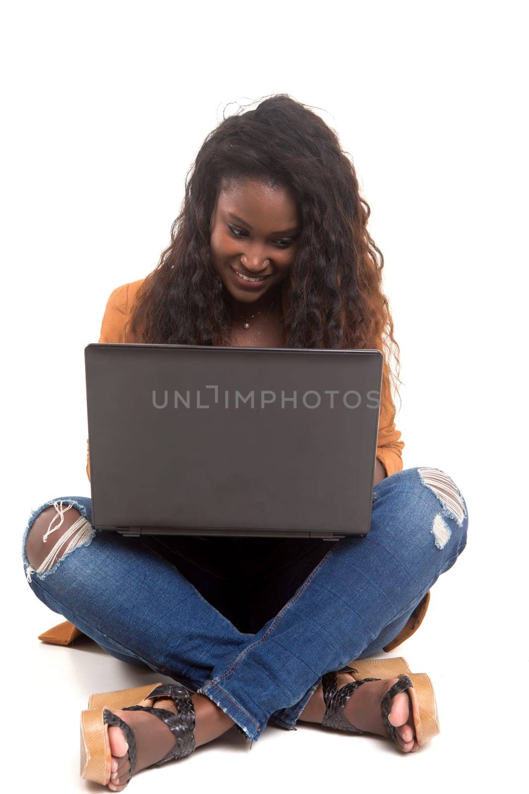 Young african student working with her laptop, isolated over a white background