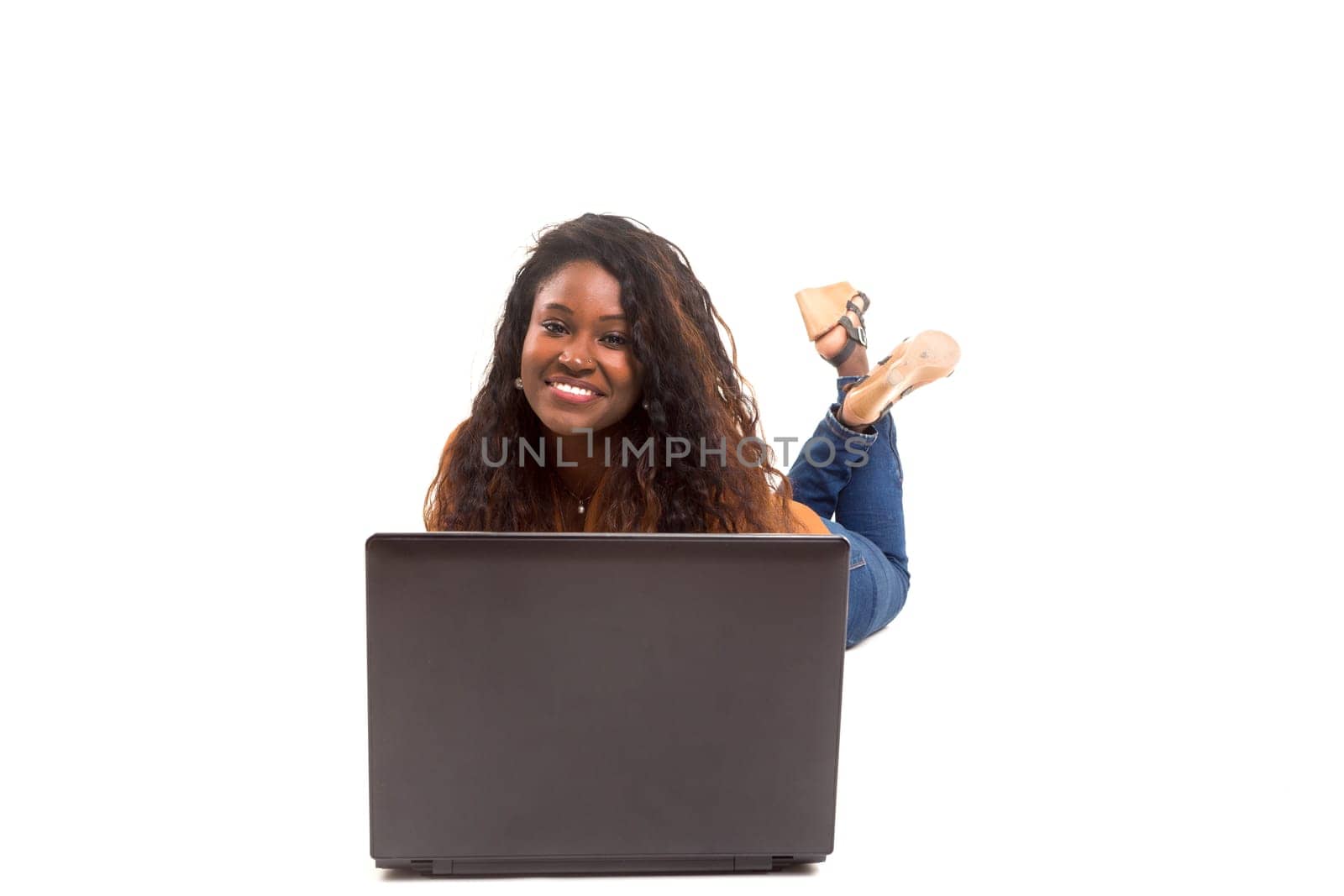 Young african student working with her laptop, isolated over a white background