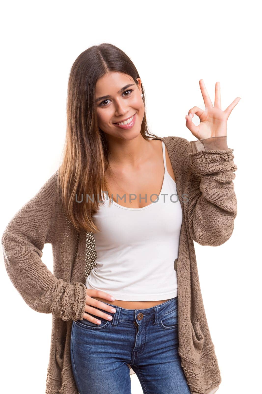 Beautiful young woman signaling ok, isolated over white