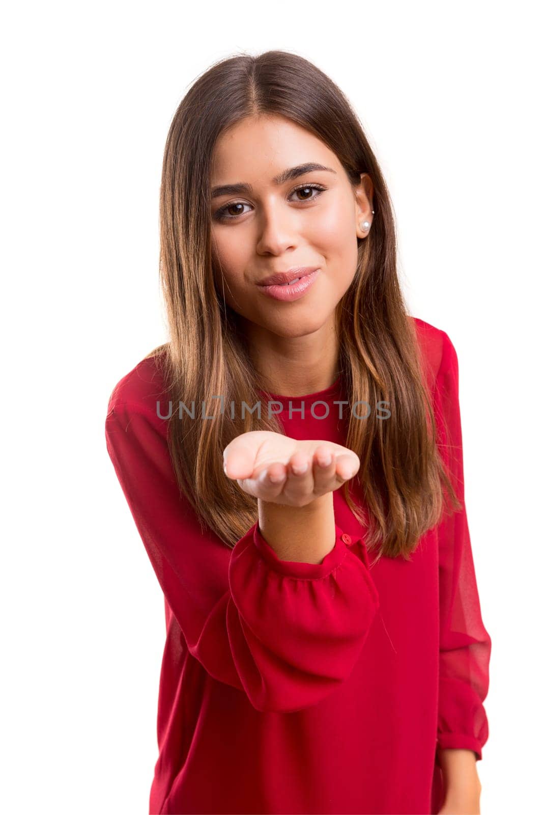 Beautiful young woman blowing you a kiss, isolated over white