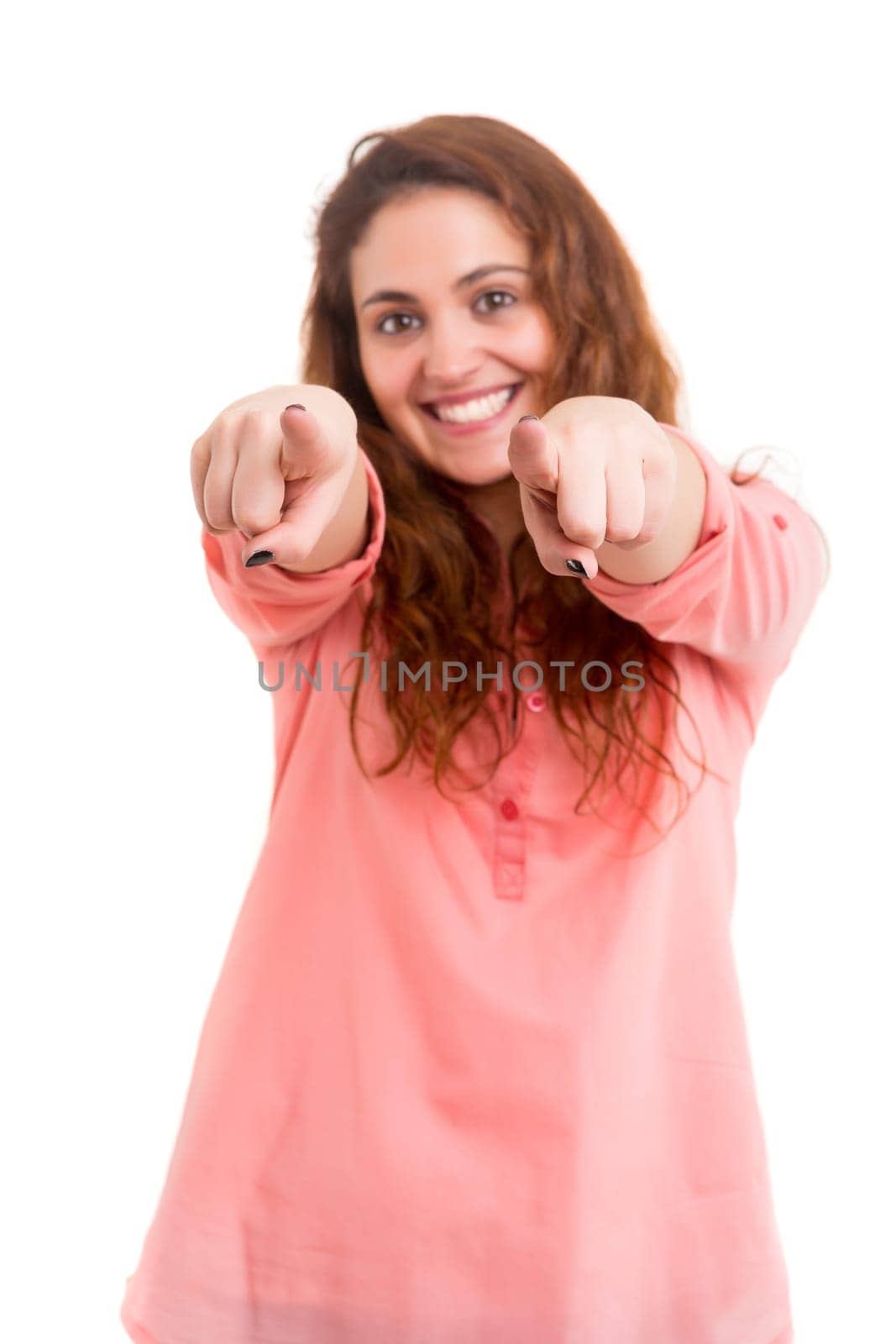 Young beautiful woman pointing at you, isolated over white