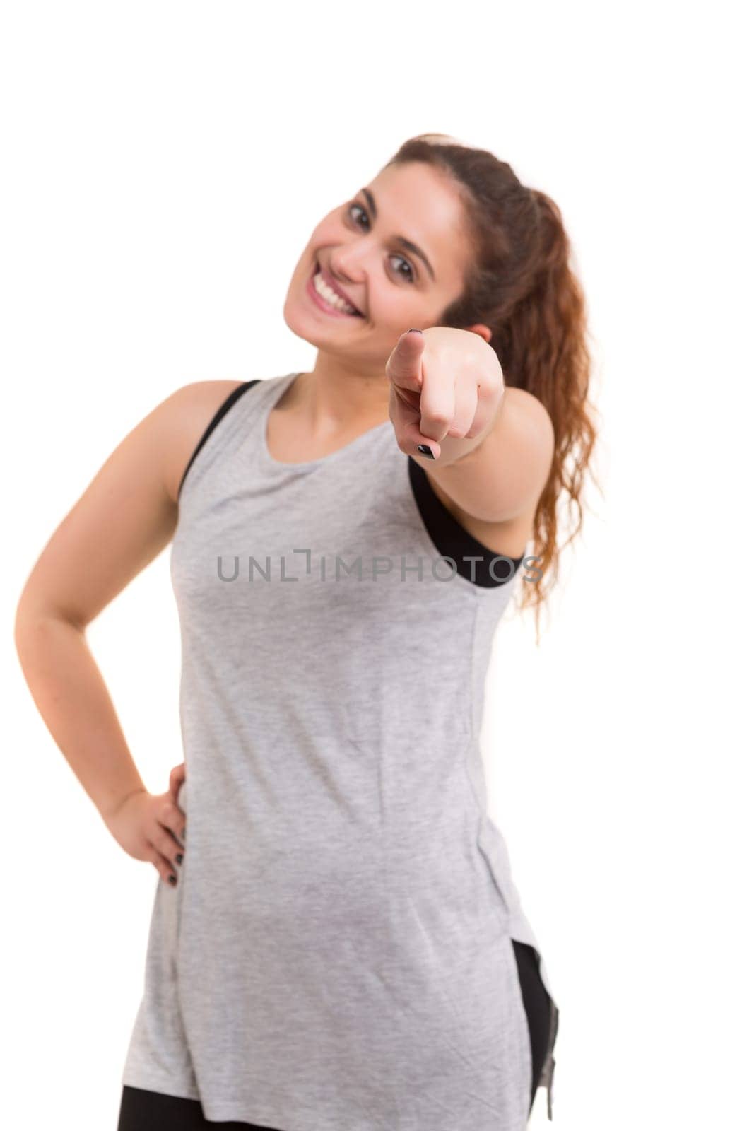 Young woman pointing her finger at you calling to exercise