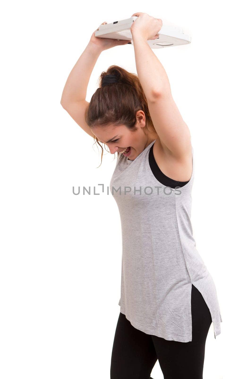 Diet concept - Mad woman destroying her scale