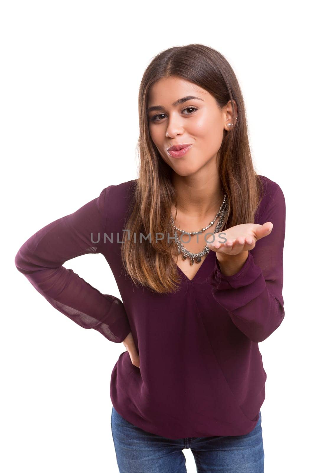Beautiful young woman blowing you a kiss, isolated over white