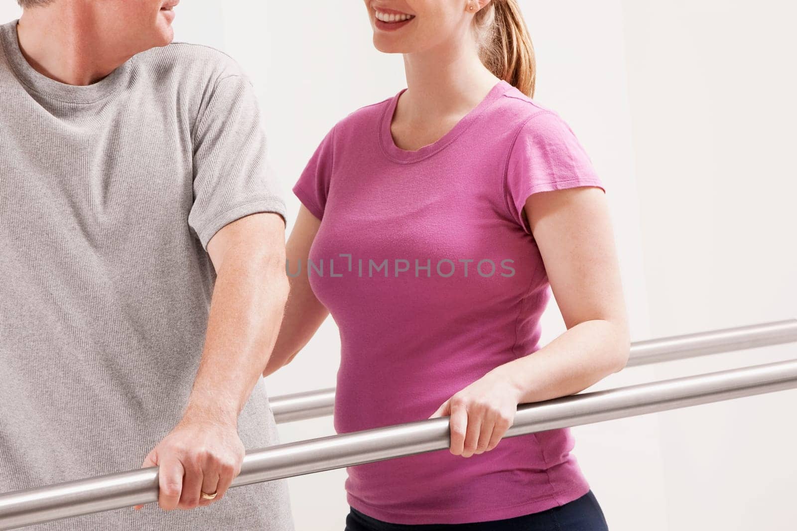 Physiotherapist assisting a patient in walking