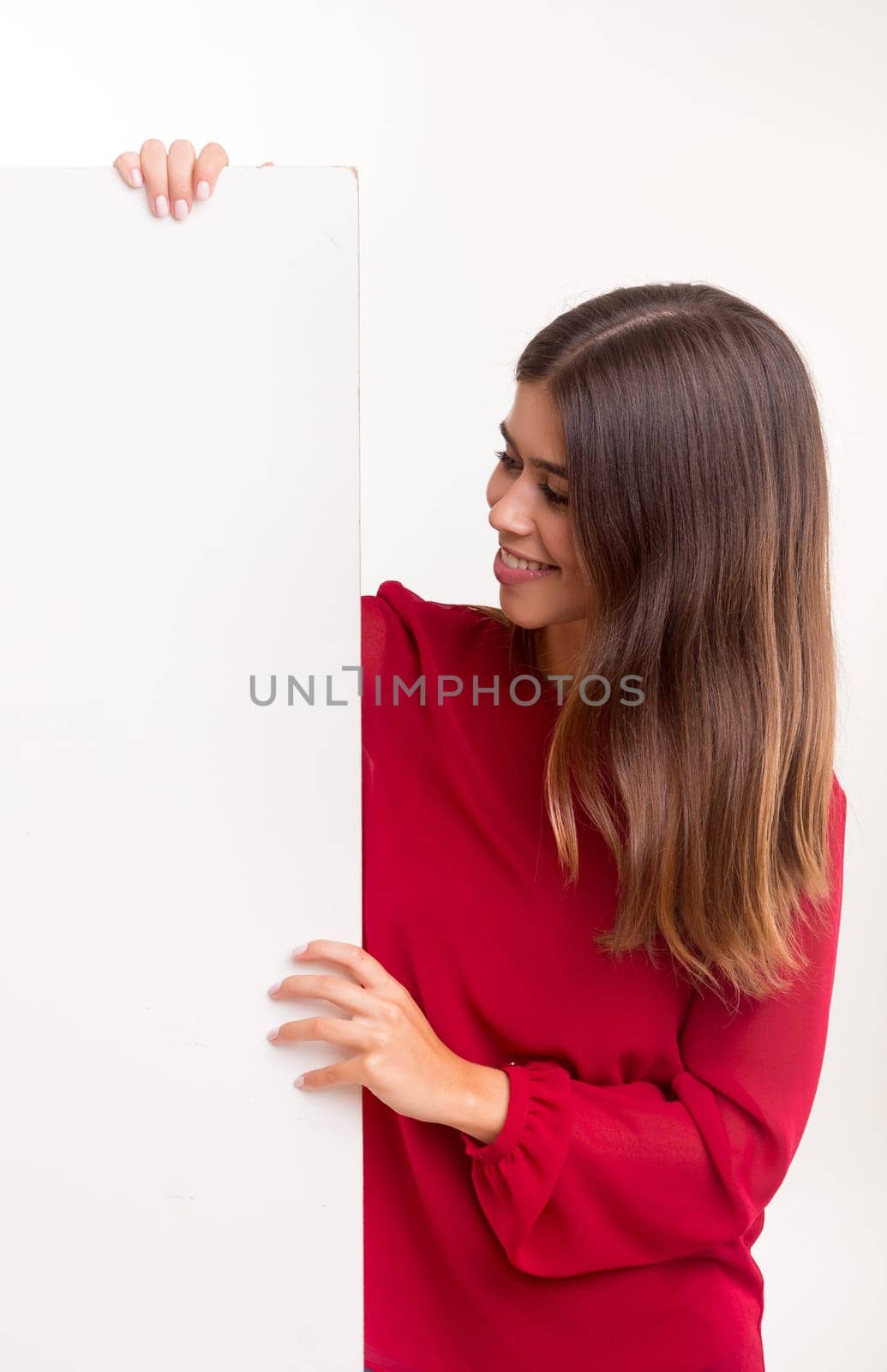 Beautiful young business woman presenting your product on a white card