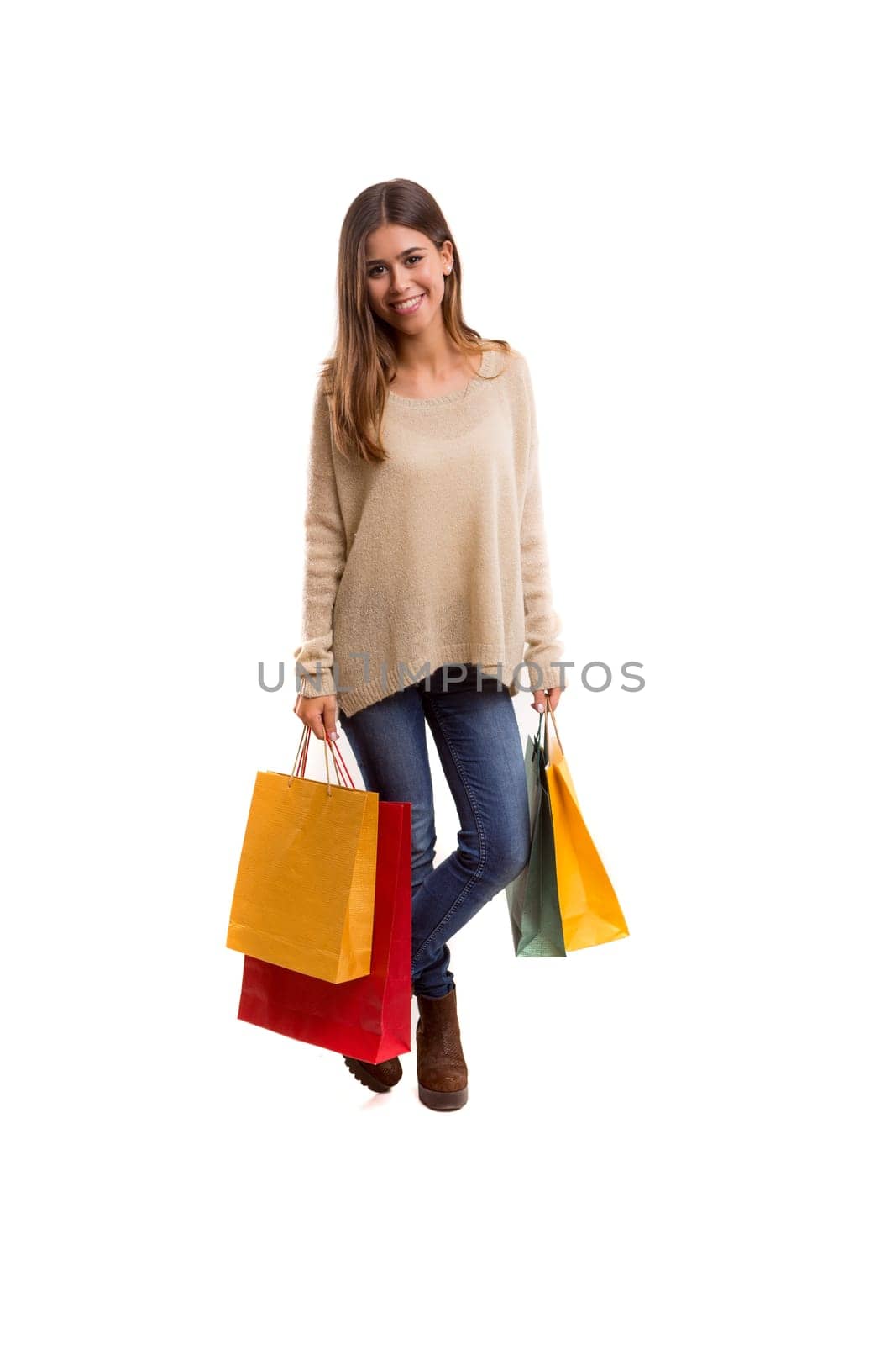 Young beautiful woman with shopping bags, isolated over copy space background