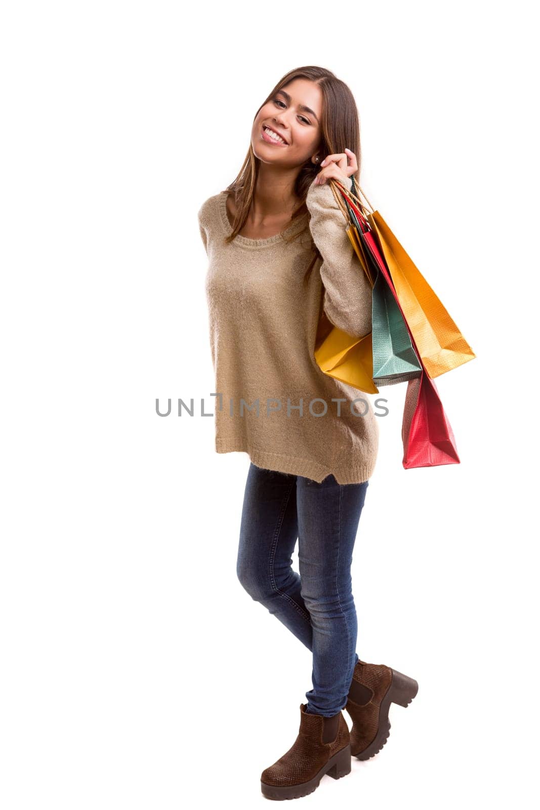 Young beautiful woman with shopping bags, isolated over copy space background