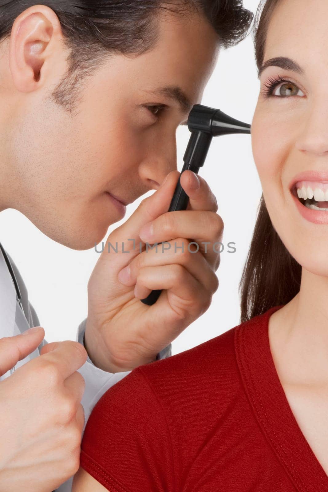 Doctor examining a womanŽs ear with an otoscope