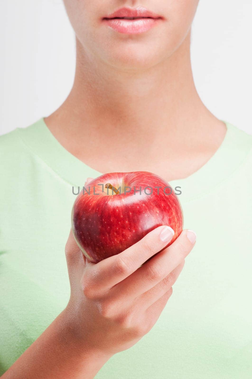 Close_up of a woman holding a red apple