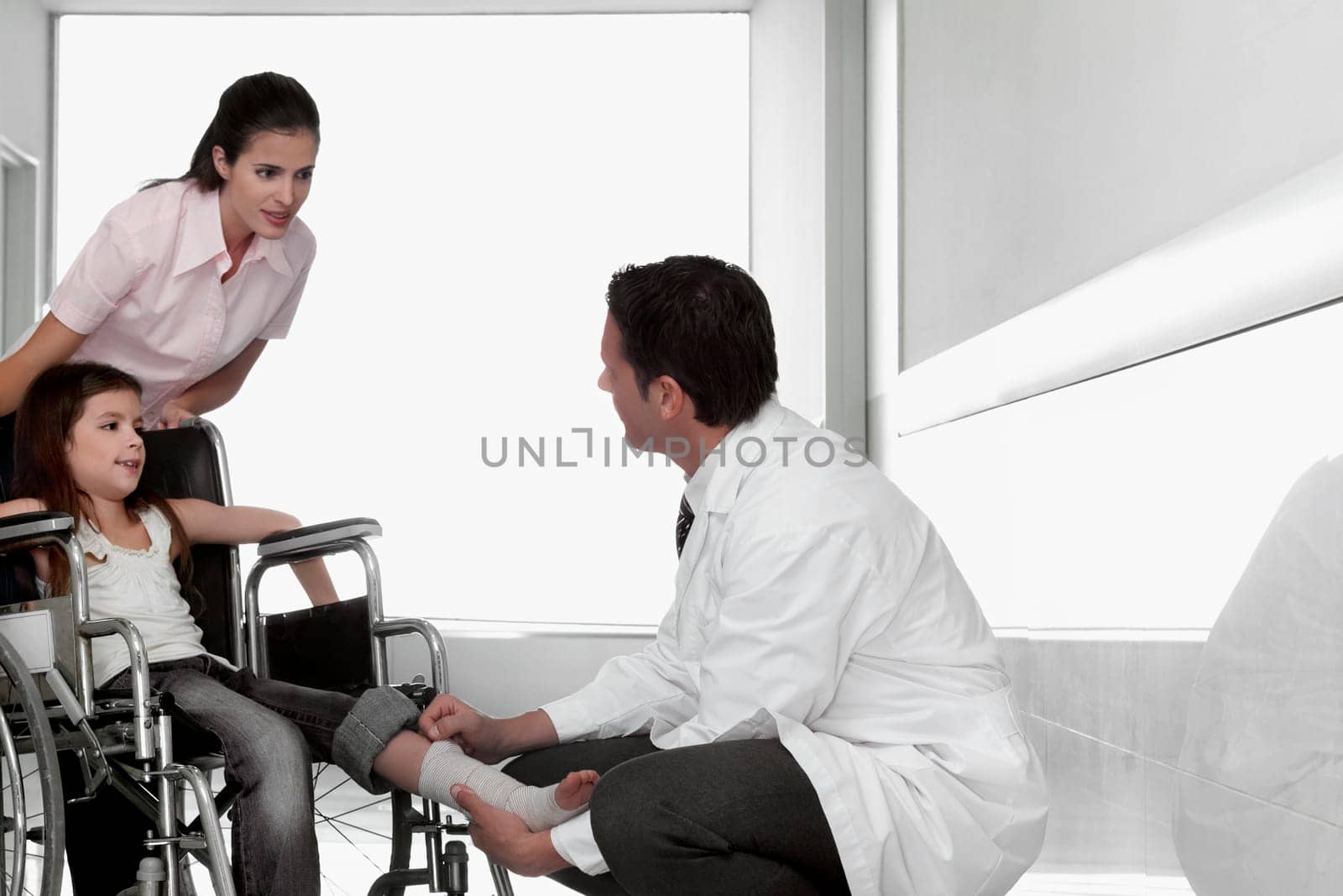 Two doctors with a patient sitting in a wheelchair