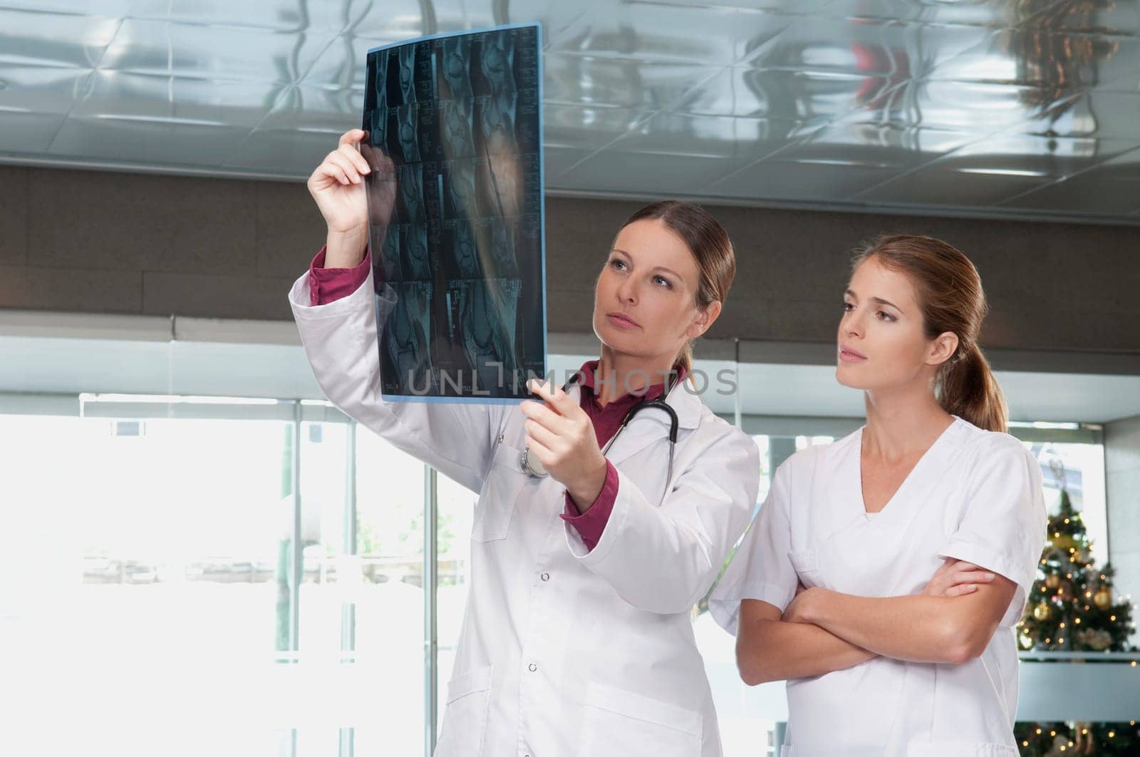 Female doctor showing MRI scan report to a nurse