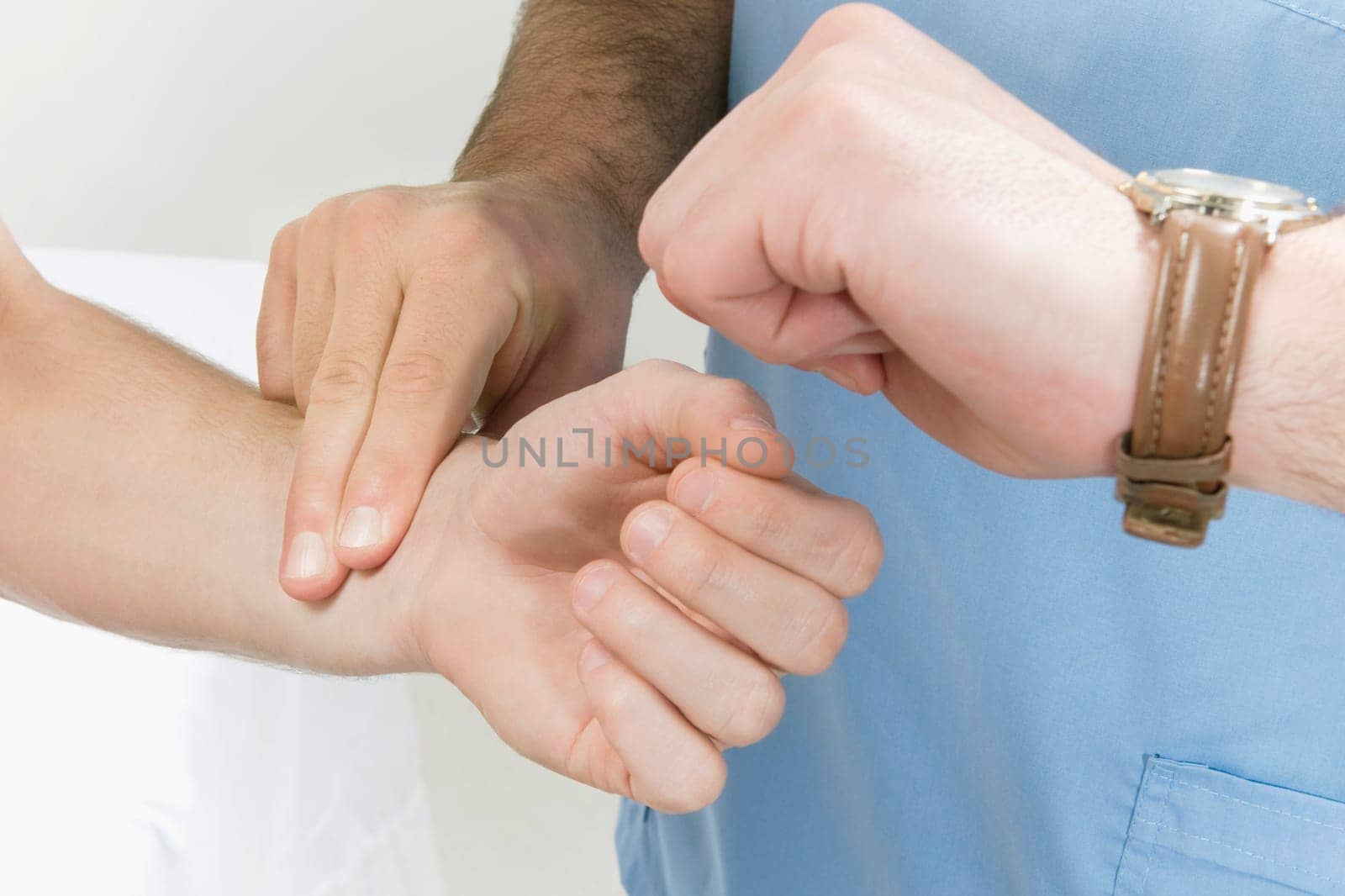 Doctor taking pulse of a patient