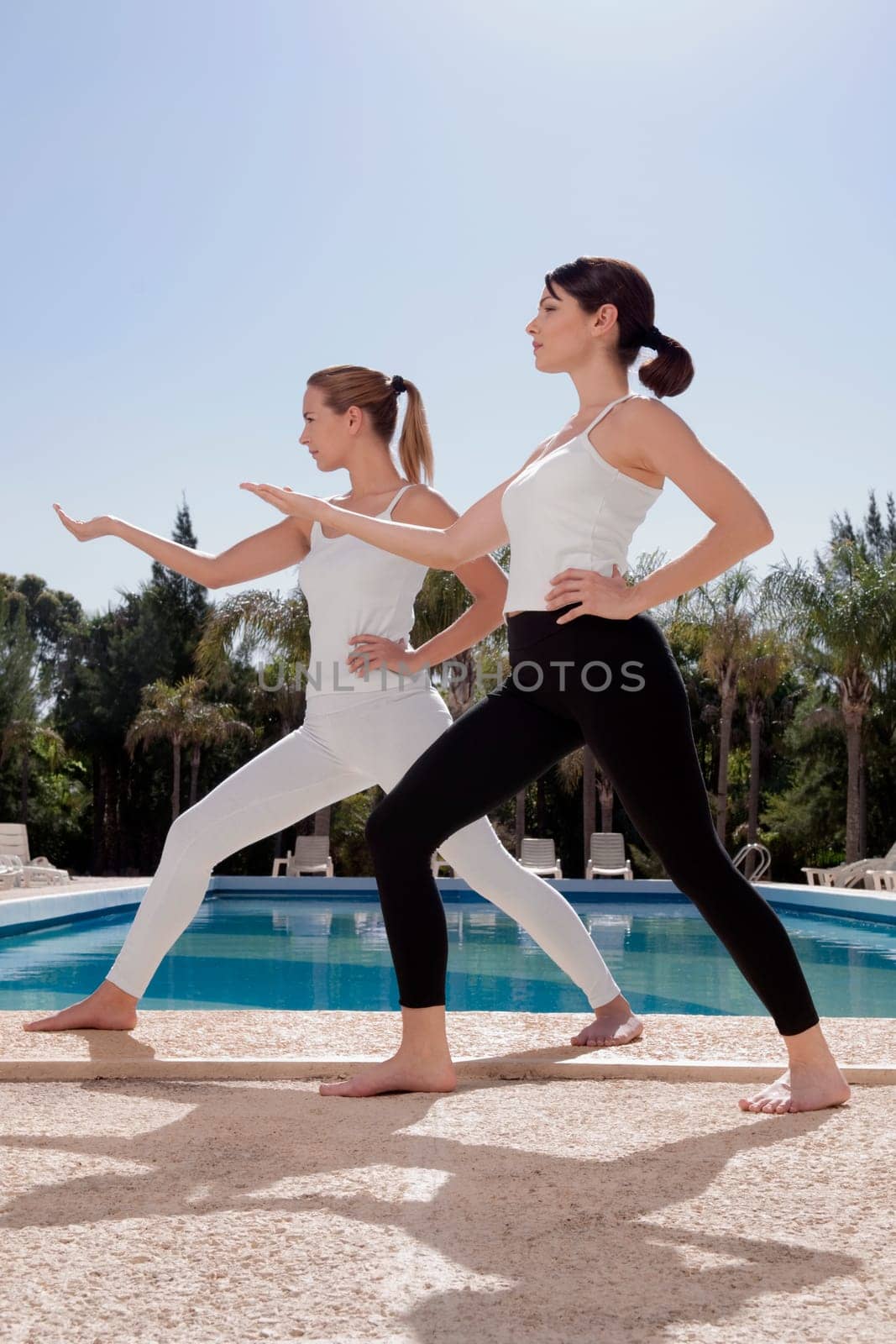 Women exercising at the poolside