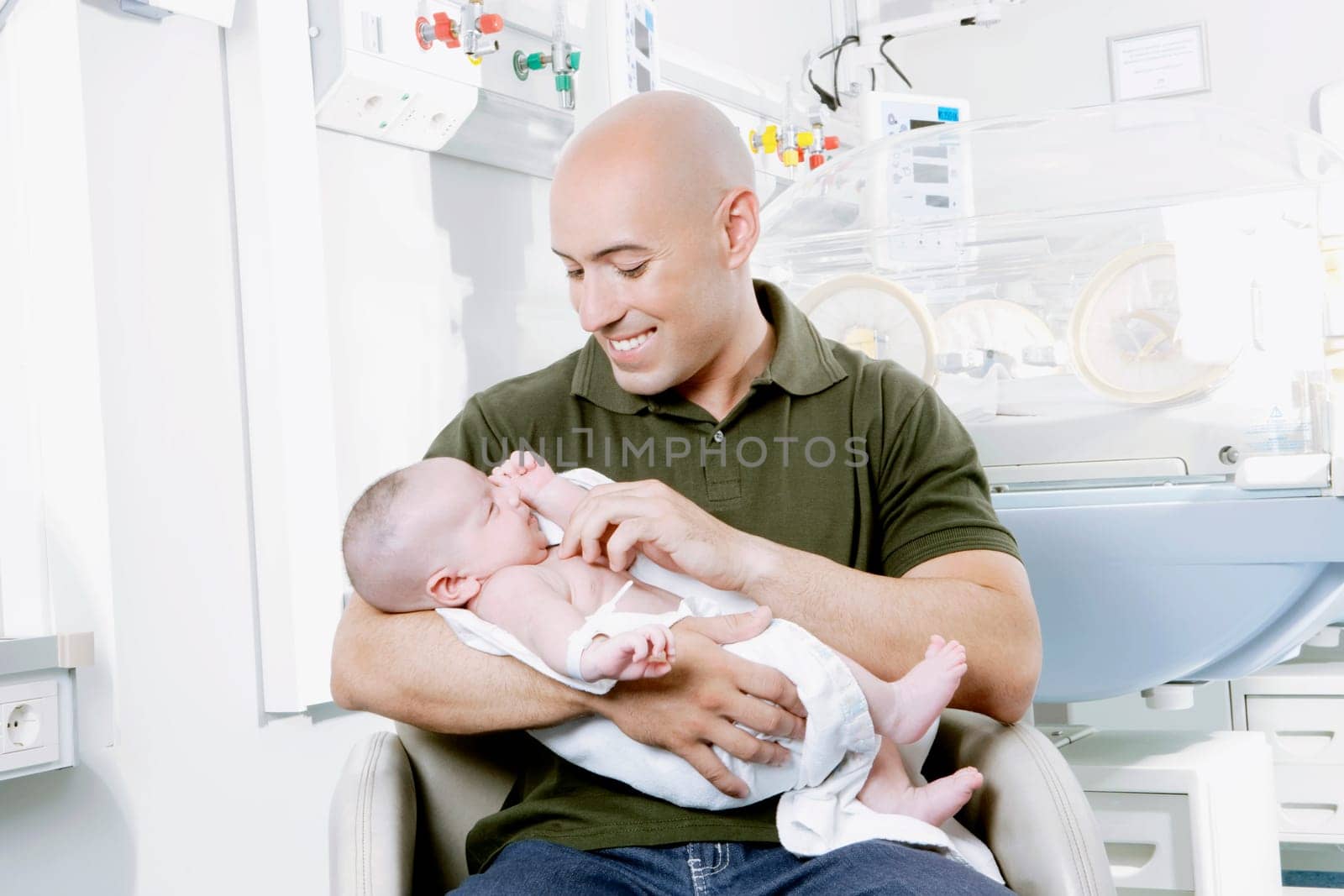 Man carrying his newborn baby